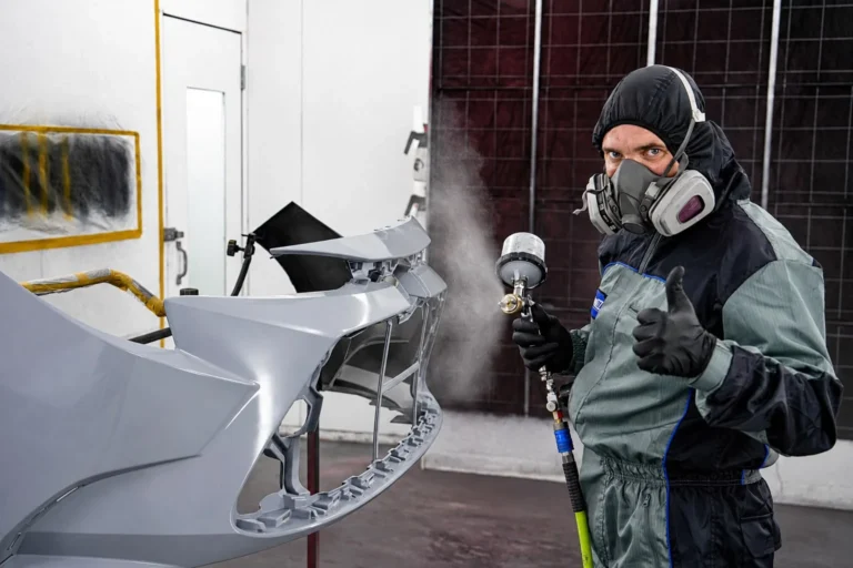 Kent Auto Body paint technician working in the spray booth